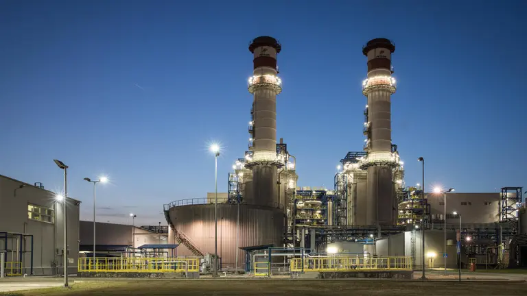 Brazi power plant seen from the front with its two towers at dusk