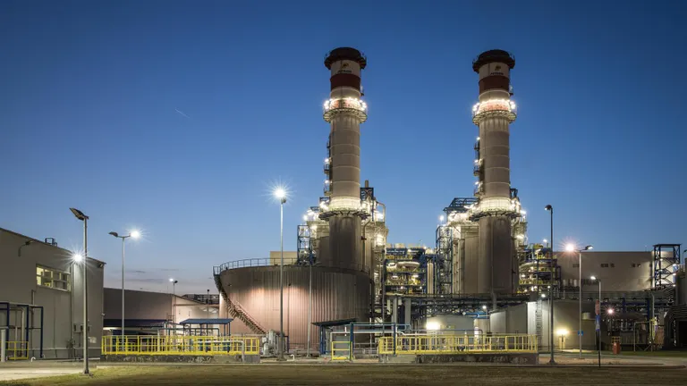 Brazi power plant seen from the front with its two towers at dusk