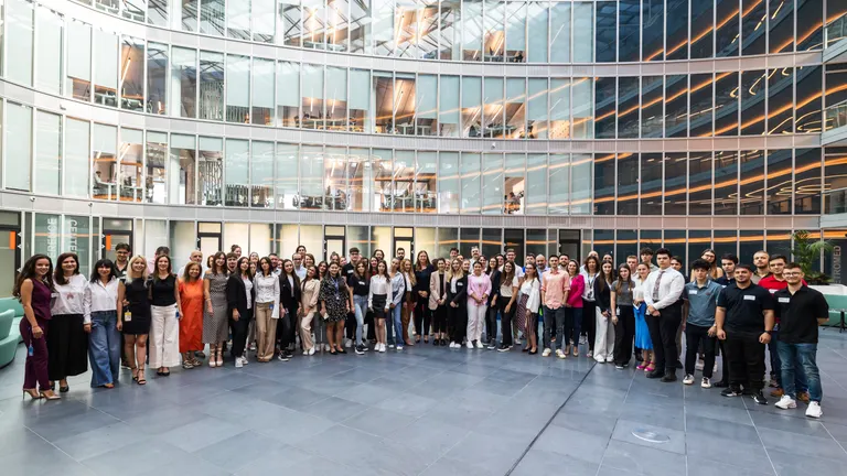 A croud of interns and employees from OMV Petrom posing together as a group photo in Petrom City, the company's headquarters.